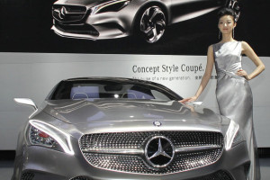 A model stands next to a Mercedes-Benz Concept Style Coupe at Auto China 2012 in Beijing